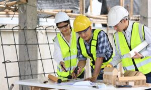Engineers reviewing site plans and measurements before project approval to confirm property boundaries