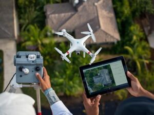 Drone conducting an aerial survey over a residential property while a land surveyor reviews high-resolution aerial imagery and site data on a tablet in West Palm Beach, Florida.