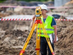 Licensed land surveyor reviewing drainage elevations, easements, utilities, and stormwater improvements in West Palm Beach Florida.